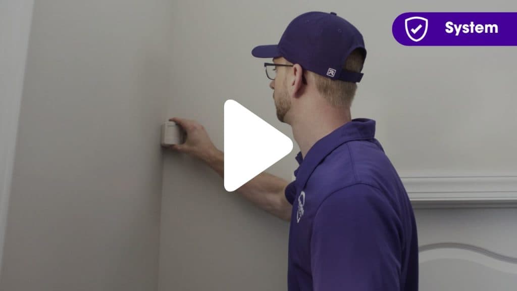 Guardian Protection installer putting a motion sensor up in home