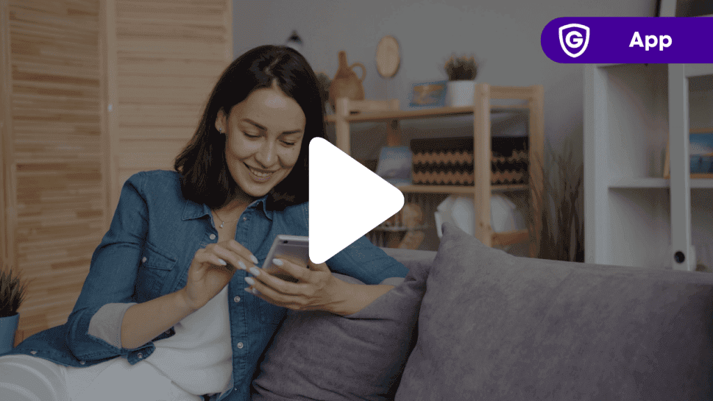 Woman sitting on couch looking at her mobile phone