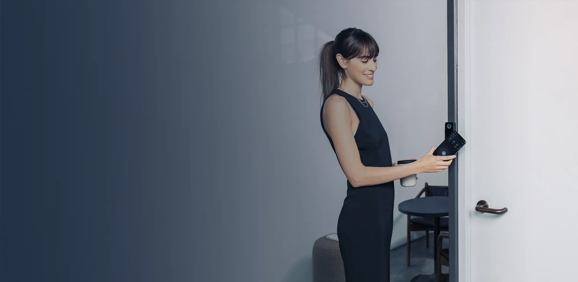 Man sitting at a table in a restaurant working on a laptop computer.