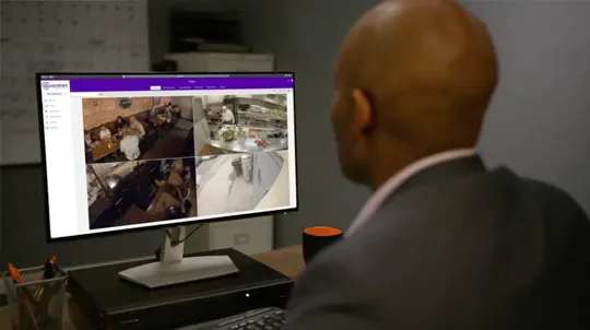 Small business owner checking in on his Guardian Protection security cameras