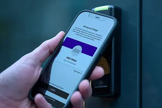 Person using their smart phone to access a building