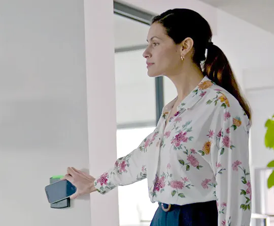 Woman using Guardian Protection's access control system