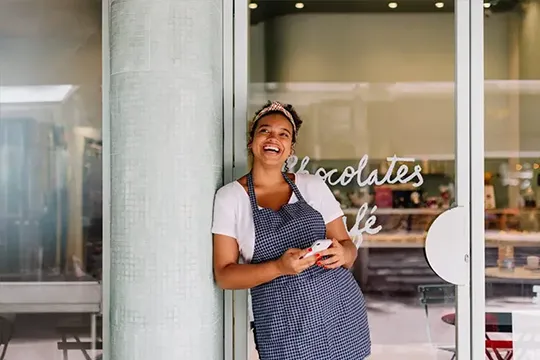Business owner standing in front of her store
