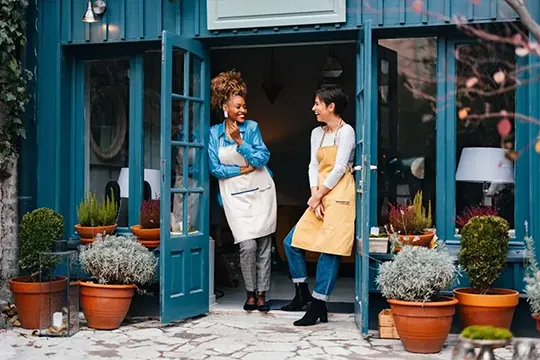 Two women standing in front of their small business