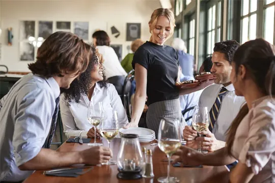 Waitress serving customers at restaurant