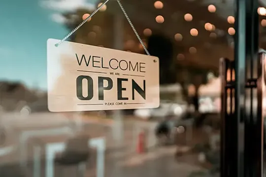 'Open' sign hanging in a store window