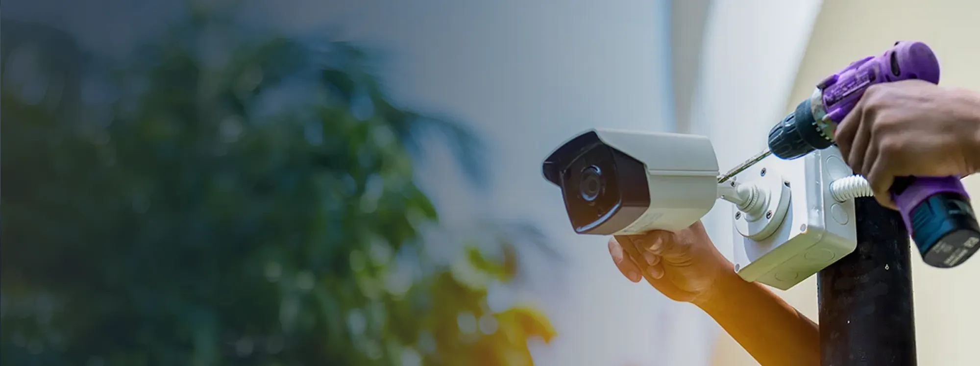 Technician installing a business security camera