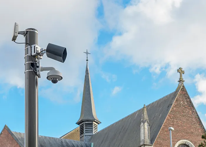 Security camera overlooking a church parking area.