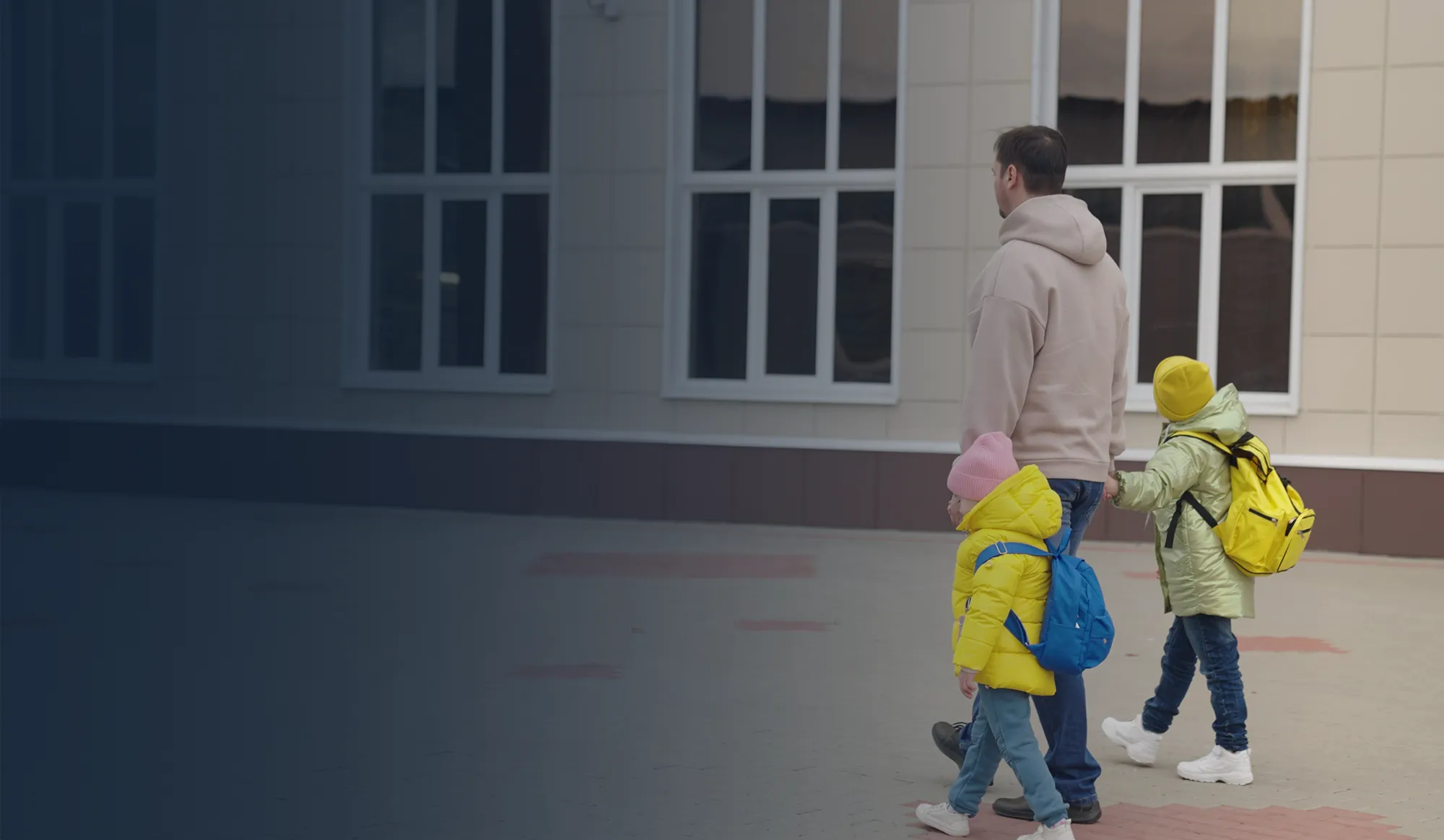 School administrator reviewing security footage at a desk.