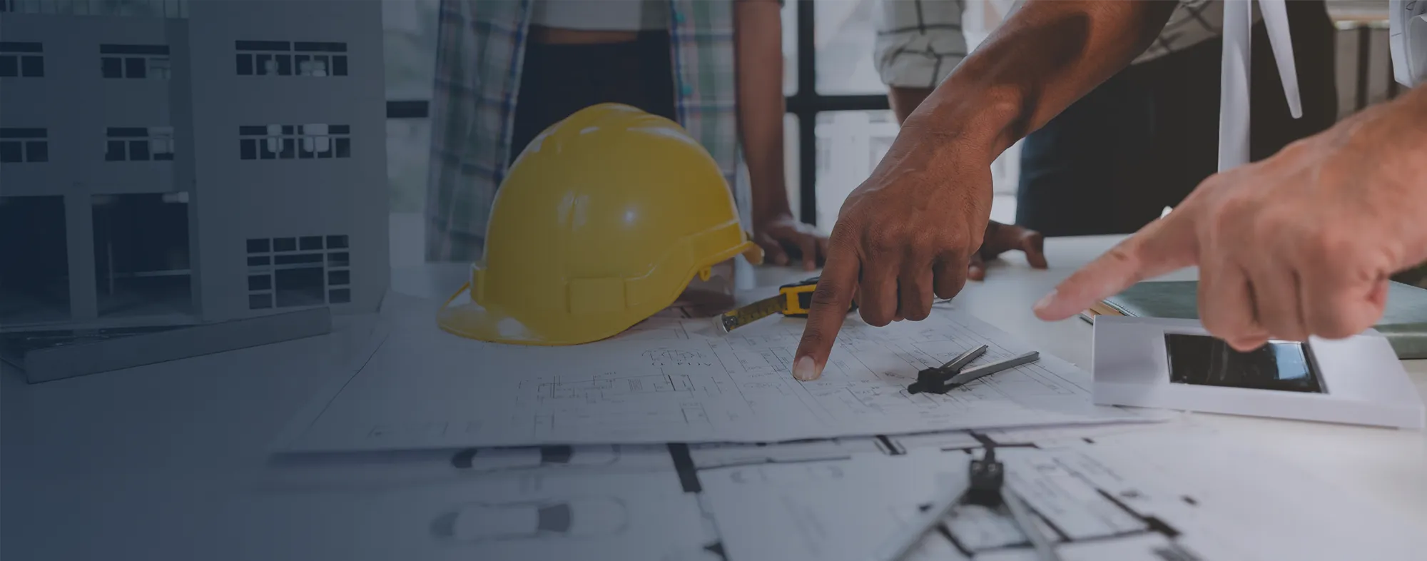 People going over a blueprint of a building.