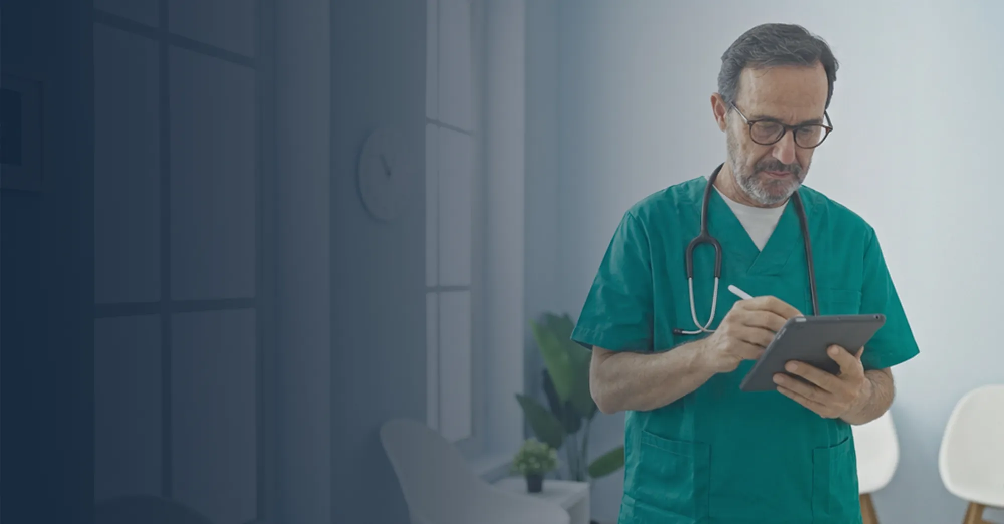 Healthcare administrator using a tablet device with a stylus.