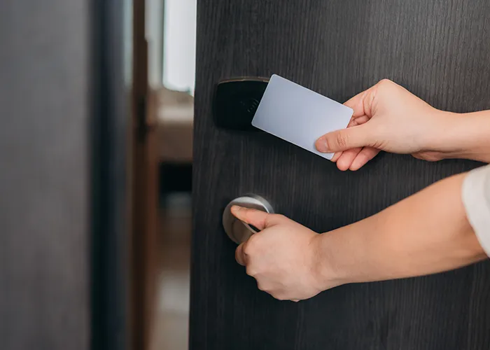 Hotel staff using a mobile device to manage access control.