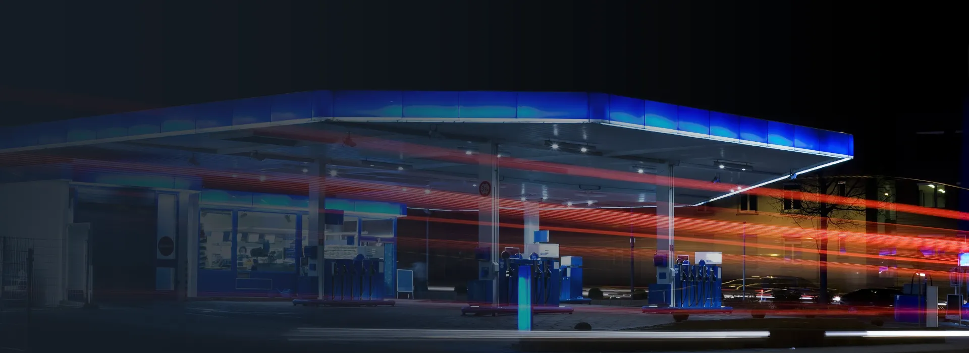 A service station and gas pumps at night