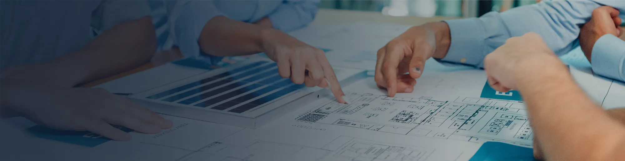 Guardian team examining a floor plan diagram.
