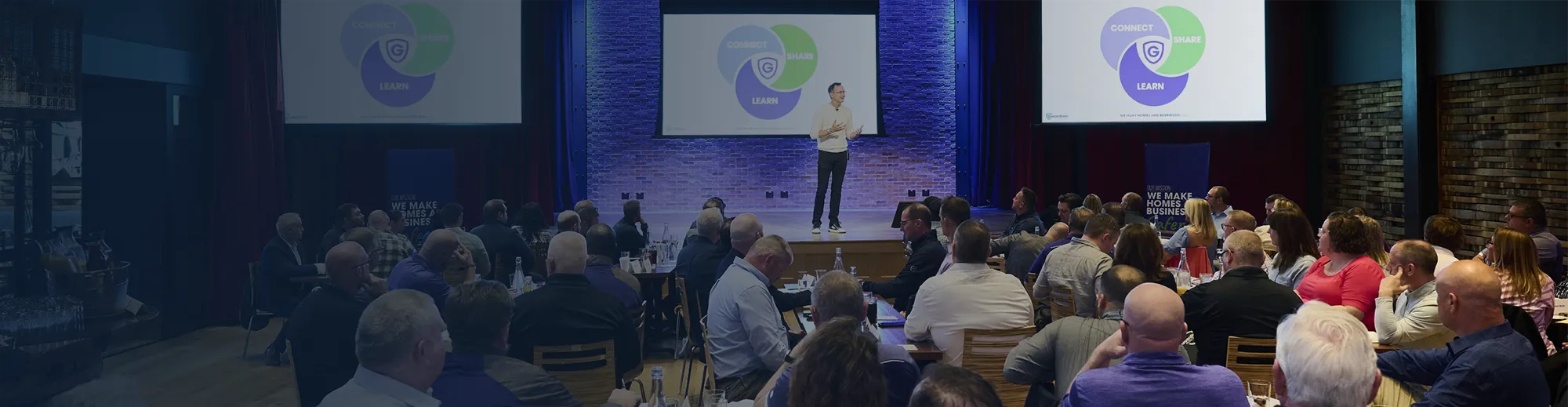 Guardian Protection presenter speaking at a company all-hands event.