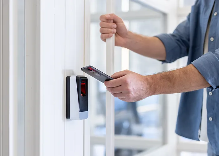 Person using a smart phone to access an apartment lobby.