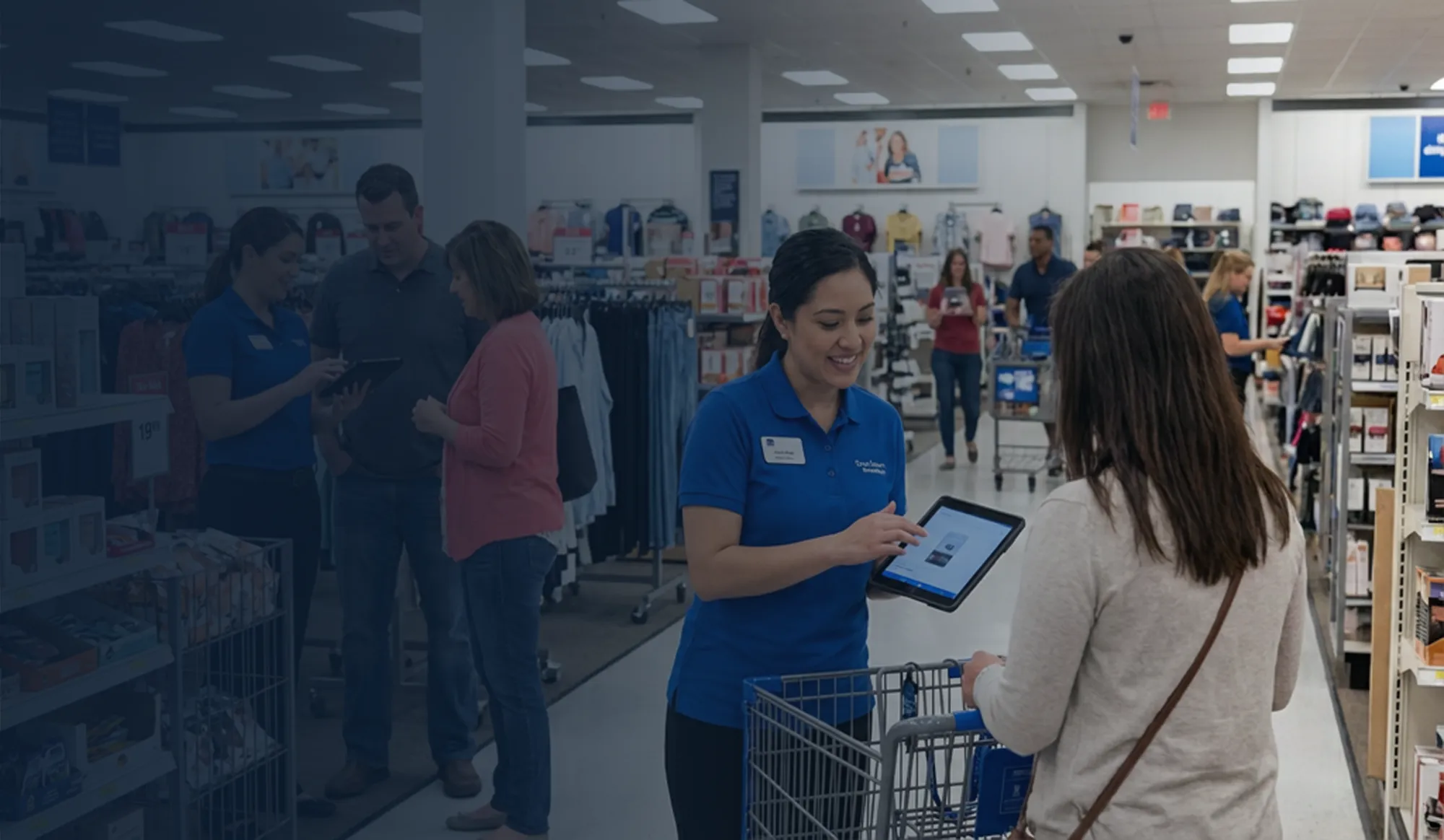 Store associates helping customers on a retail floor.