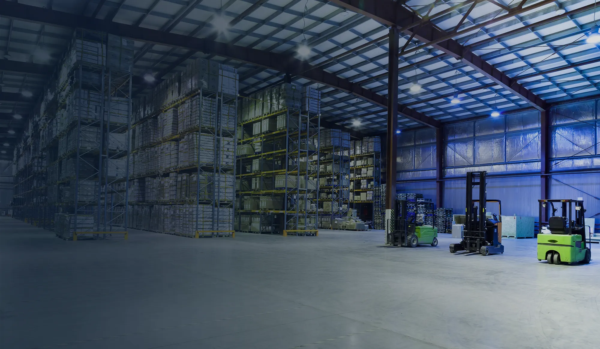 Large warehouse interior with shelving and forklifts.
