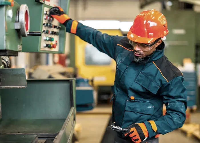 Industrial worker using heavy machinery.