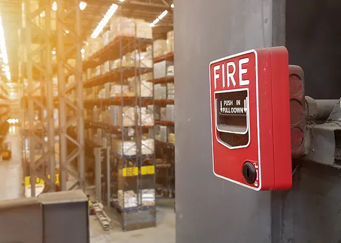 Fire alarm pull station in an industrial facility.