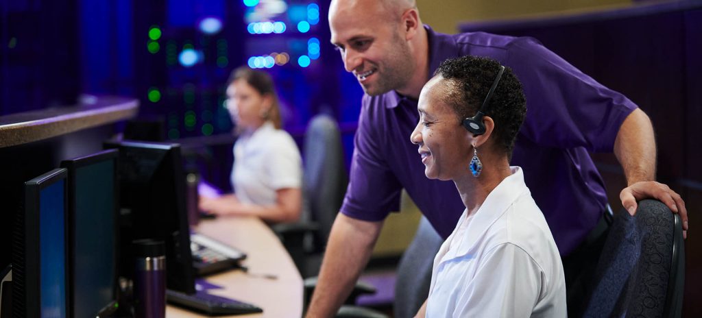 Man and woman working in Guardian Protection's Monitored Security Center.