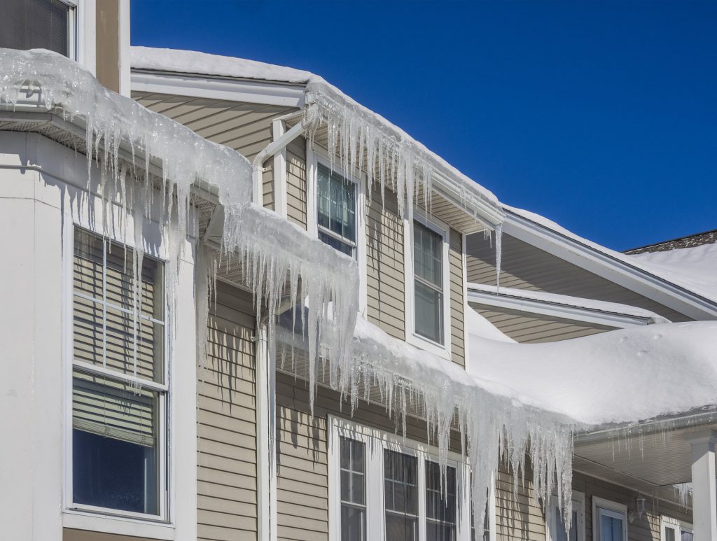 Home with multiple icicles hanging from the roof