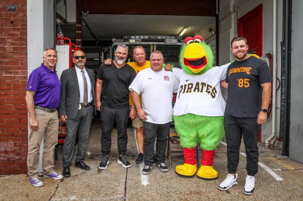 Guardian Protection team visiting local firefighters with Pittsburgh Pirates to give game tickets.