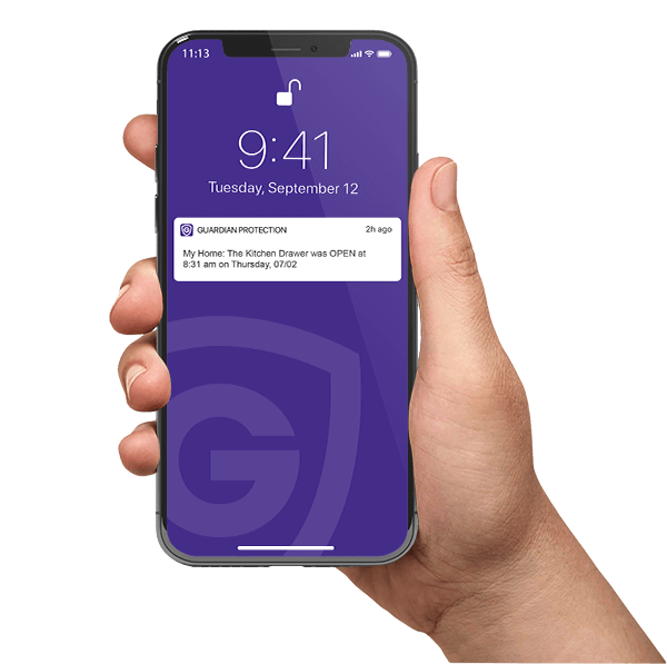 Hand holding a smart phone showing a Guardian Protection app notification 
