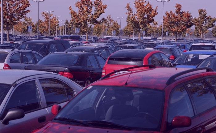 A crowded parking lot filled with vehicles