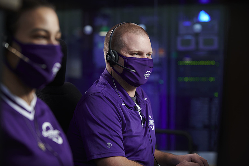 Two Guardian Protection Security Experts taking phone calls in Monitoring Center