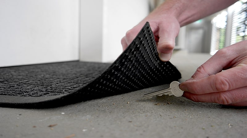 Spare key hiding under doormat