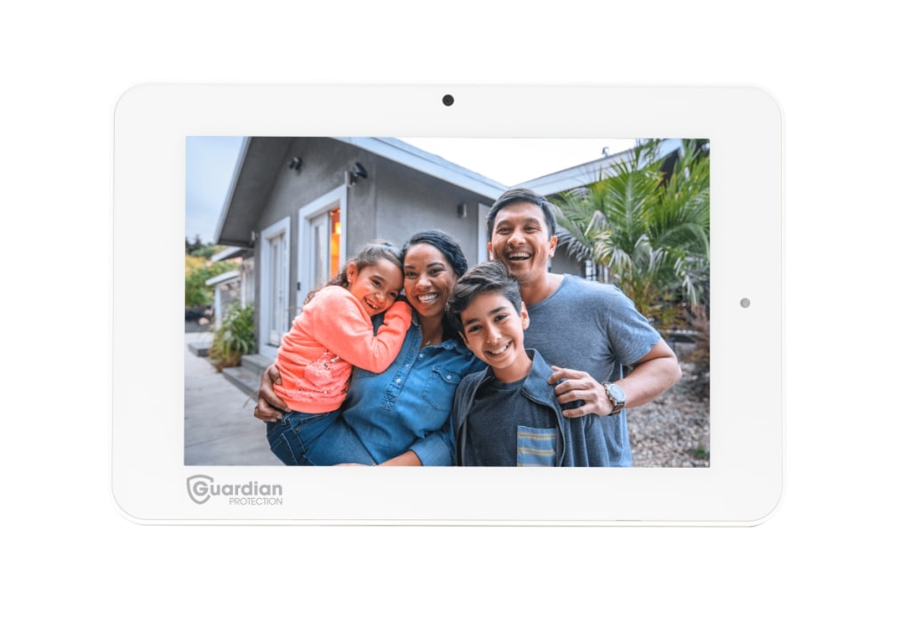 Image shows a happy family on the Guardian IQ2 home security panel. 