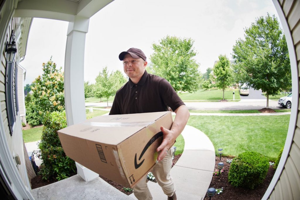 Delivery man dropping off a package as viewed by a Guardian Protection video doorbell 