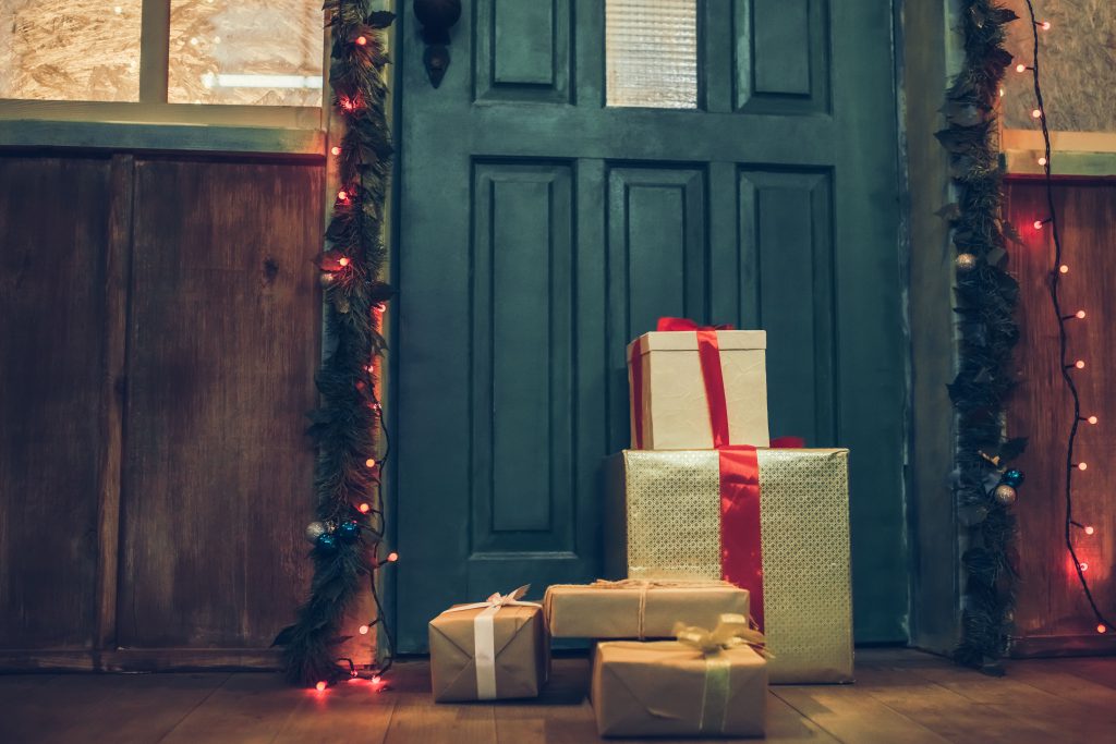 Packages and presents left on festive front porch