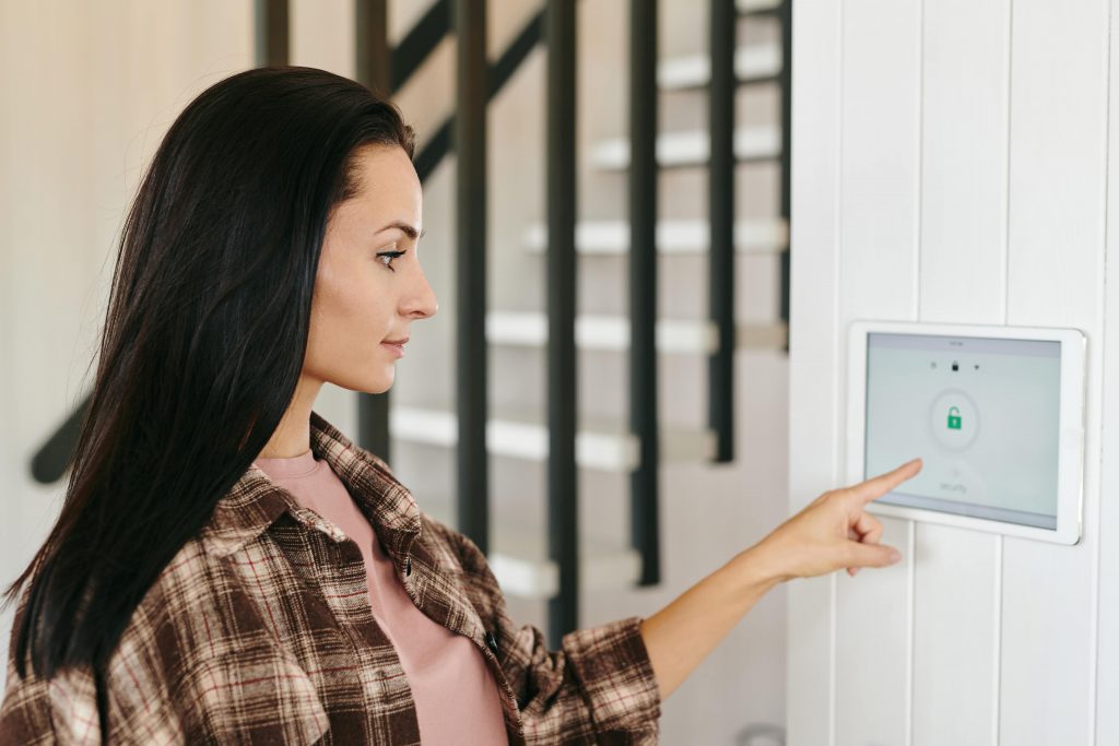 Woman using her Guardian Protection IQ4 Panel