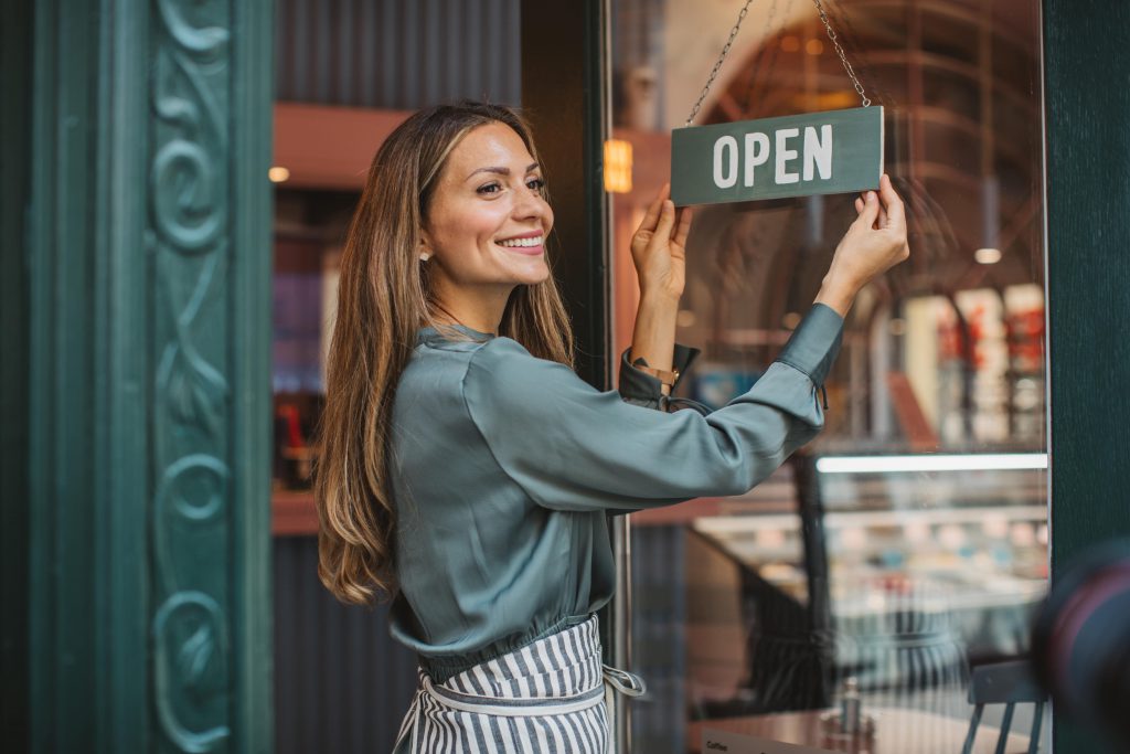 Business owner flipping her OPEN sign 