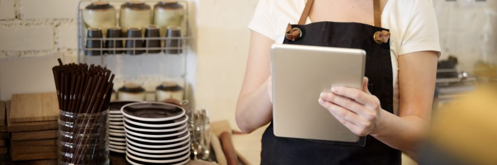 A business owner checking the Guardian Protection app on a tablet