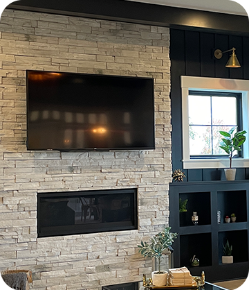 TV mounted to wall above fireplace