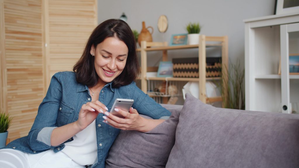 Woman on a couch using the Guardian Protection app