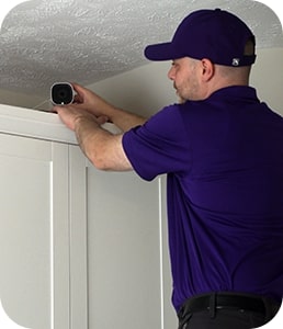 Guardian Protection technician installing an indoor camera