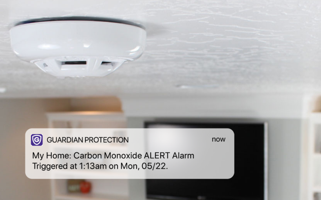Guardian Protection carbon monoxide detector with a Guardian notification saying that a CO alert has been triggered 