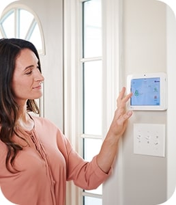 Woman looking at her Guardian Protection home security panel
