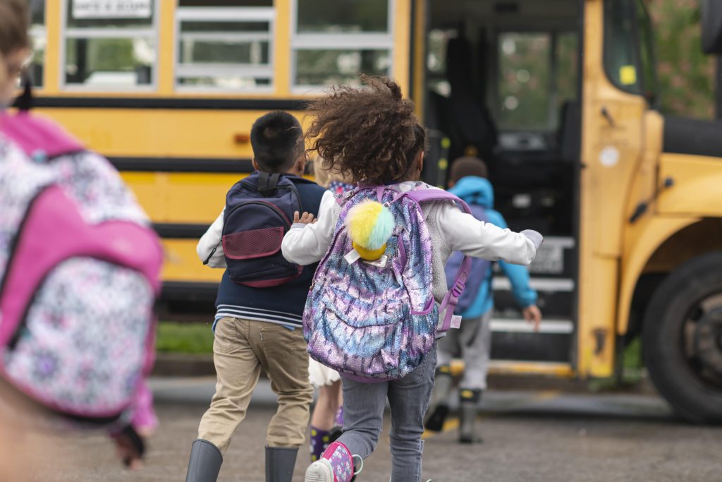 Kids getting on a school bus