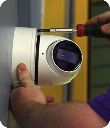 Guardian Protection technician installing a security camera indoors