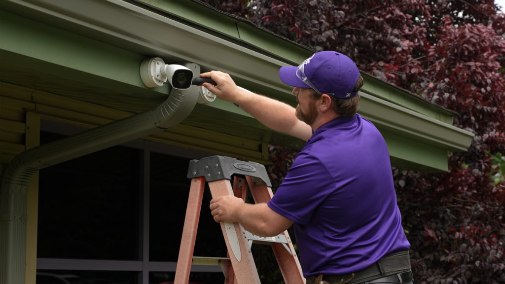 Guardian Protection technician installing one of Guardian Protection's home security cameras