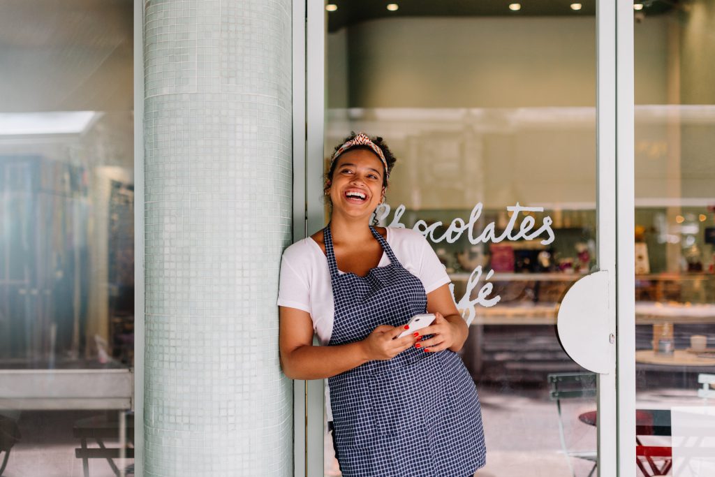 Business owner with phone out using Guardian Protection app