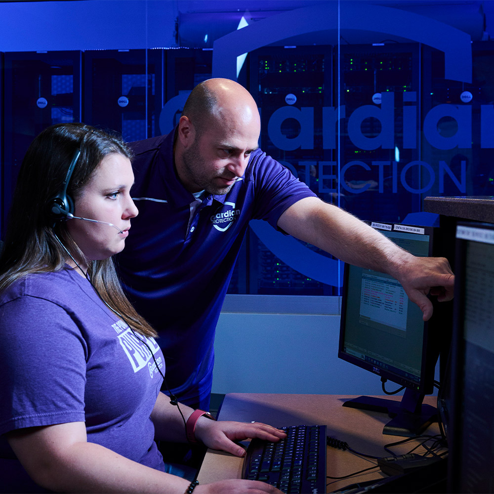 Two Guardian Protection specialists working in the Monitoring Center