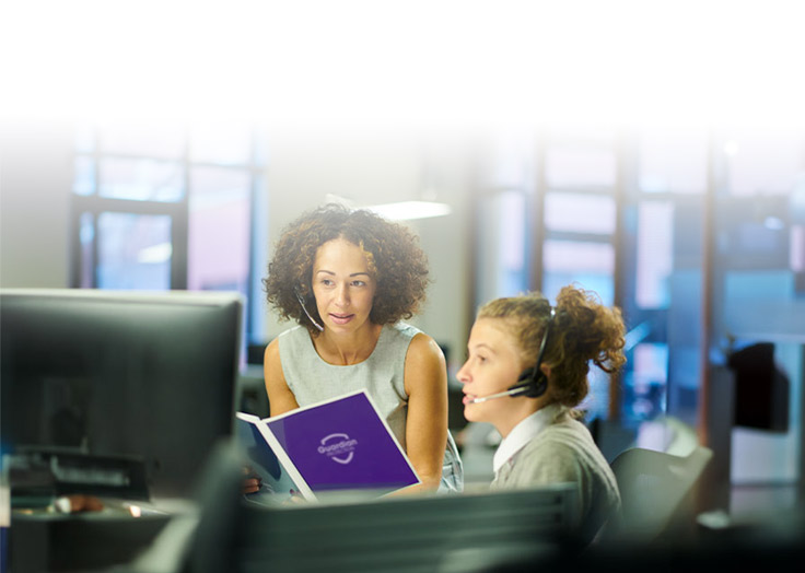 Two women working at a desk in an office