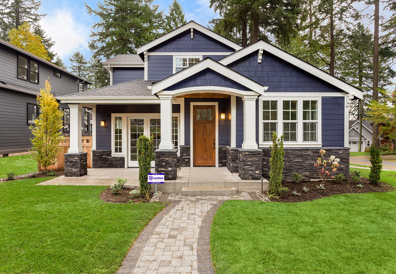 Front view of a residential home with Guardian Protection home security.