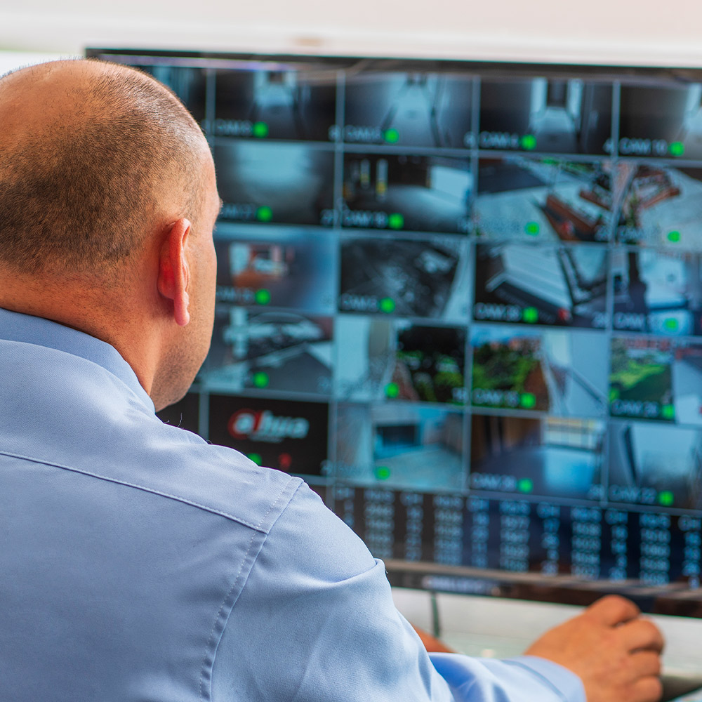 Business owner checking the live views from his Guardian Protection business security cameras